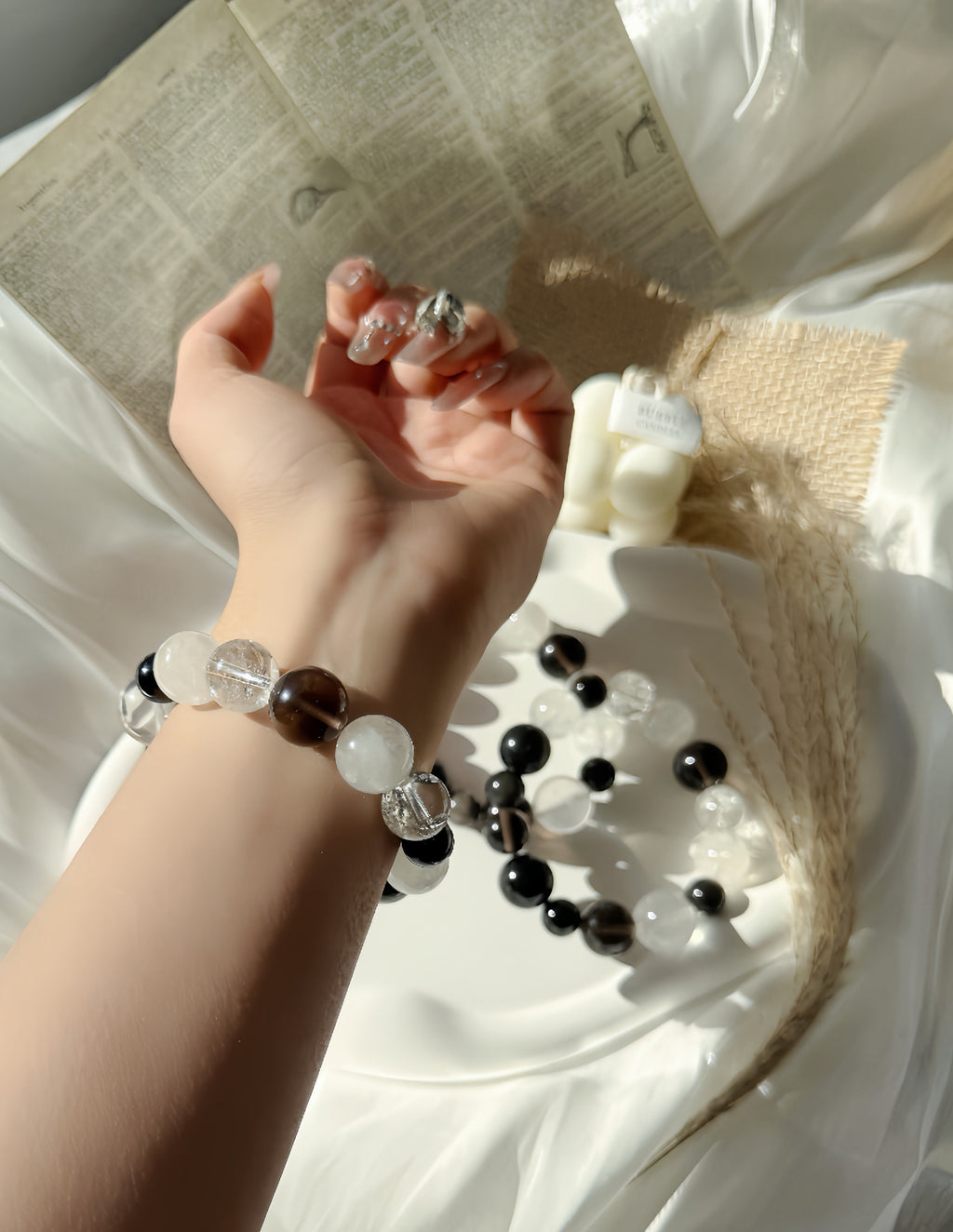 Hand wearing a beaded bracelet with a blurred background